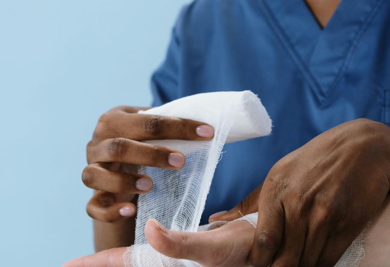 Clinician wrapping an injured hand